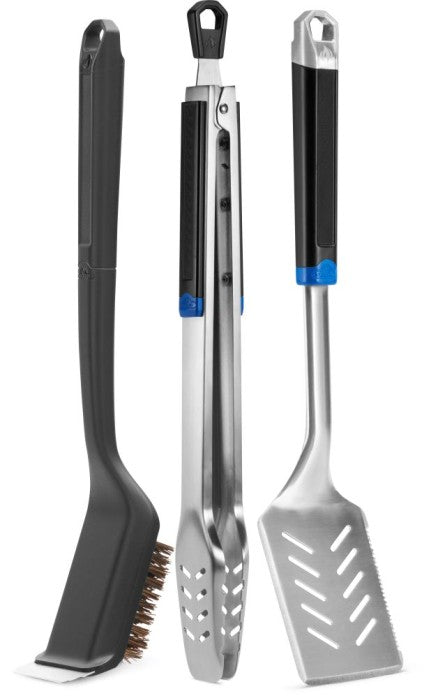 stainless steel grilling tool set including spatula, tongs, and brush for barbecue cooking.
