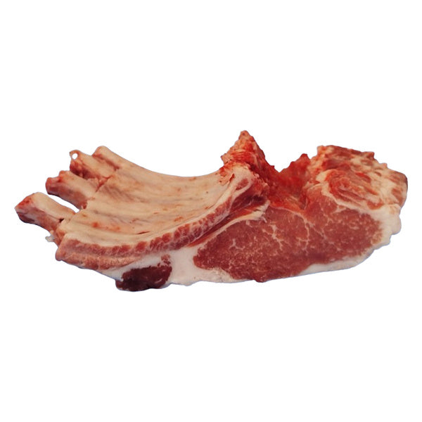 Raw Iberico 4-bone pork rack on butcher paper with herbs