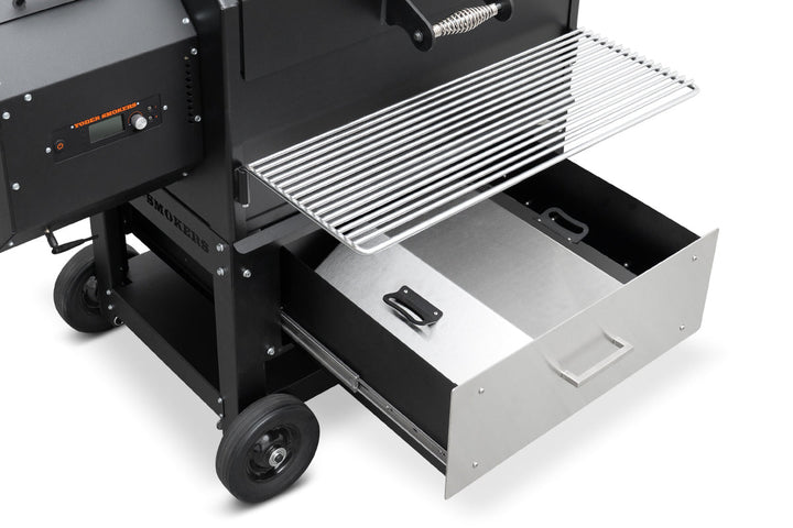 Black barbecue grill with open drawer on a white background